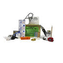 Combat survival kit with various items on a white background