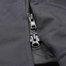 Close-up of a durable black waterproof YKK zipper on a British military rain jacket’s front closure.