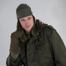 Man wearing original Czech army winter mittens gloves with free trigger finger and olive green military winter gear