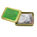 Gold combat survival tin with green label on a white background