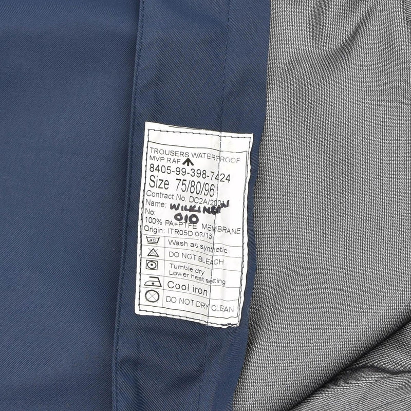 Close-up of label on genuine British RAF MVP waterproof trousers showing size and care instructions