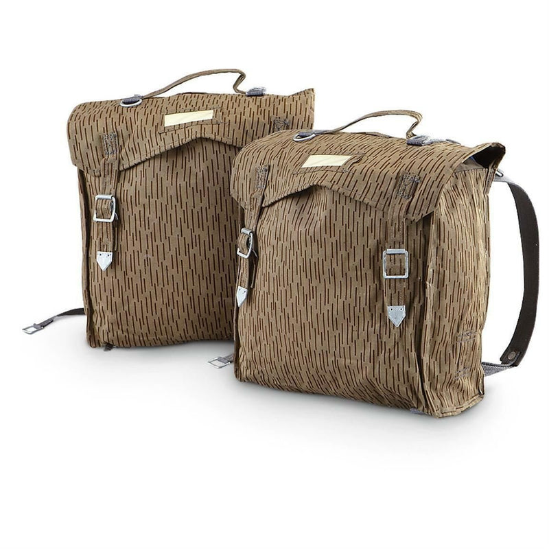 Pair of genuine East German army military rucksacks with raindrop camo and adjustable straps on white background