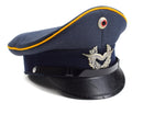 Vintage German Luftwaffe Air Forces blue peaked visor cap with insignia and yellow trim, leather brim, wool blend material.