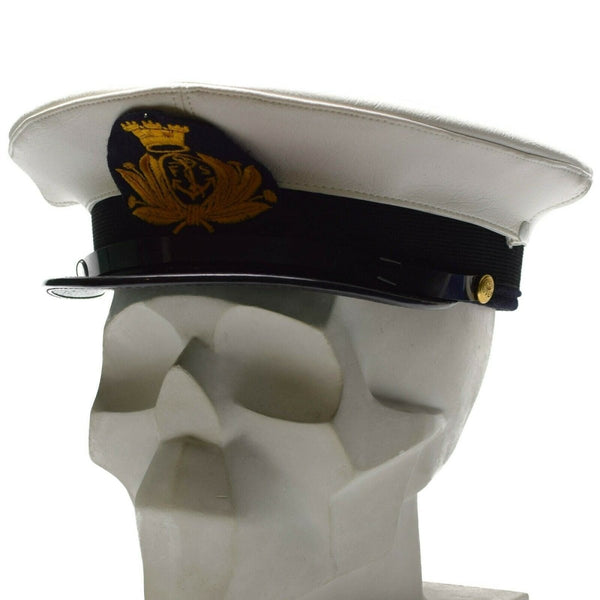 White Genuine Italian Navy peaked cap with gold insignia and black leather chinstrap on skull model