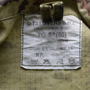 Close-up of care label on Italian Army Rip Stop Vegetato camo ACU combat jacket showing fabric composition and washing instructions