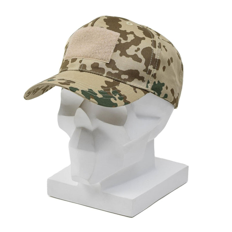 Tropentarn camouflage military baseball cap with peaked brim displayed on white mannequin head.