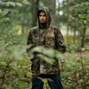 Man wearing Mil-Tec German army GoreTex Flecktarn camo waterproof rain jacket in forest setting
