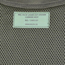 Close-up of olive mesh fabric with MIL-TEC laser cut system carrier vest label and product number.