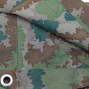 Close-up of original German military camouflage fabric with metal grommet on vintage poncho tent shelter