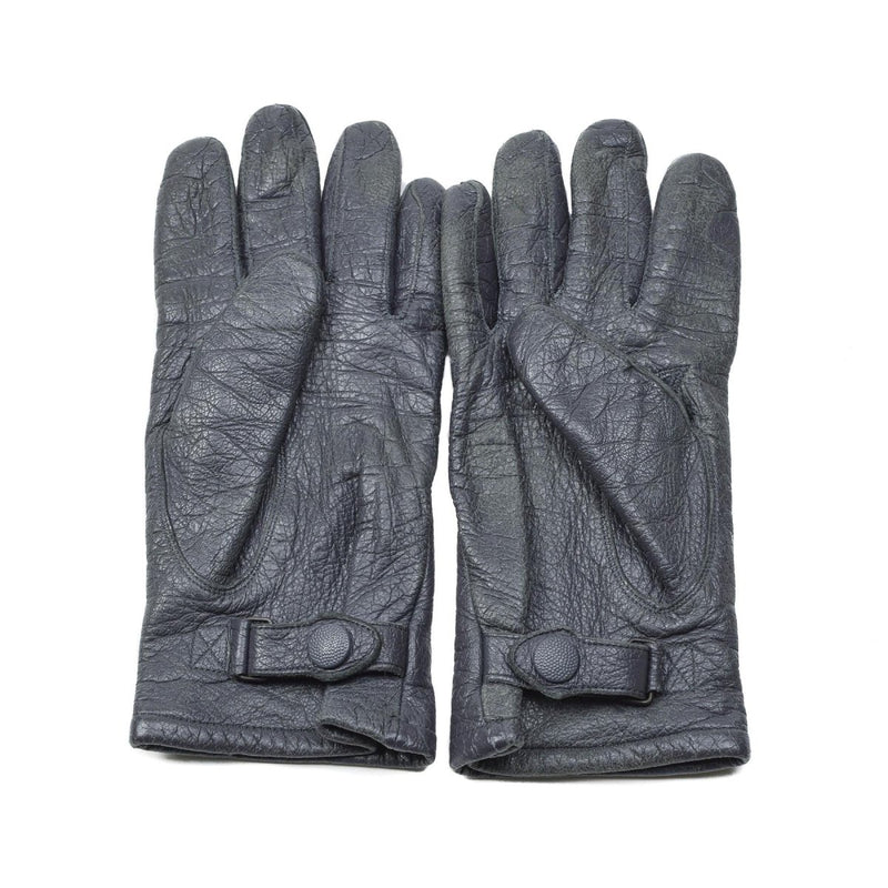 Pair of original German military surplus black leather gloves with adjustable wrist straps on white background