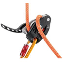Black Petzl Neox assisted braking belay device with orange climbing rope and locking carabiner for top-rope climbing safety.