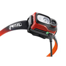 Petzl Swift RL rechargeable orange headlamp with adjustable strap and USB charging cable connected.