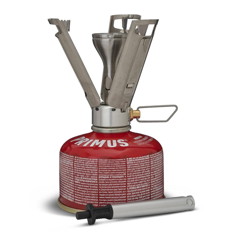 Primus Firestick Titanium lightweight hiking stove mounted on a red gas canister with foldable pot supports and igniter.