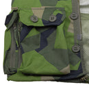 Close-up of splinter camo ripstop fabric with buttoned flap pocket and YKK zipper on military style jacket