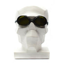 WWII genuine Swiss army mountain round helmet goggles with dark protective lenses on a white mannequin head.